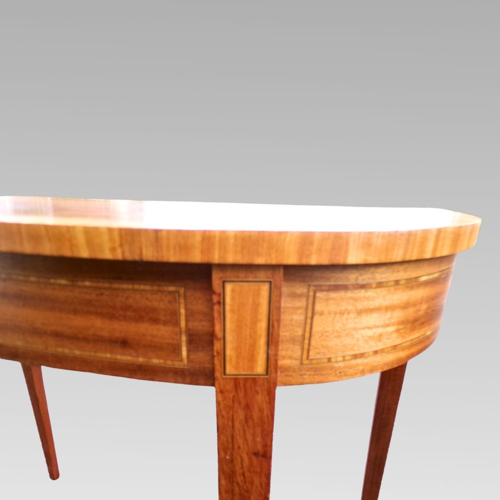 A Georgian style semicircular satinwood console table featuring crossbanded veneer borders and square tapered legs. View V
