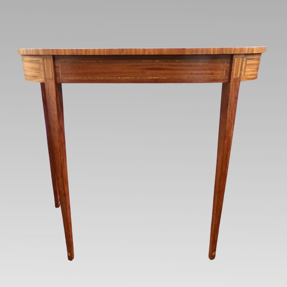 A Georgian style semicircular satinwood console table featuring crossbanded veneer borders and square tapered legs. View VI