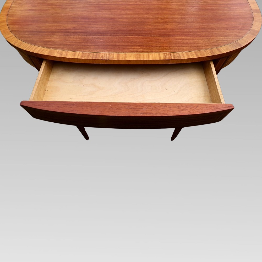 A Georgian style semicircular satinwood console table featuring crossbanded veneer borders and square tapered legs. View VII