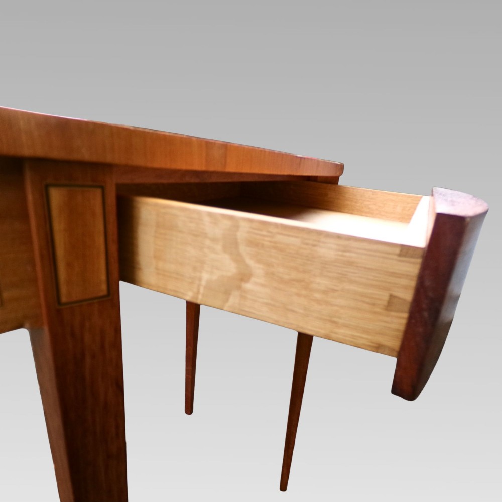 A Georgian style semicircular satinwood console table featuring crossbanded veneer borders and square tapered legs. View VIII