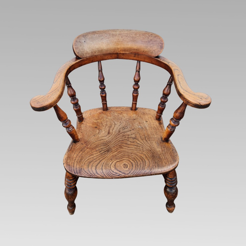A nineteenth-century turned wood smokers bow armchair featuring a shaped elm seat and turned beech spindles. View II
