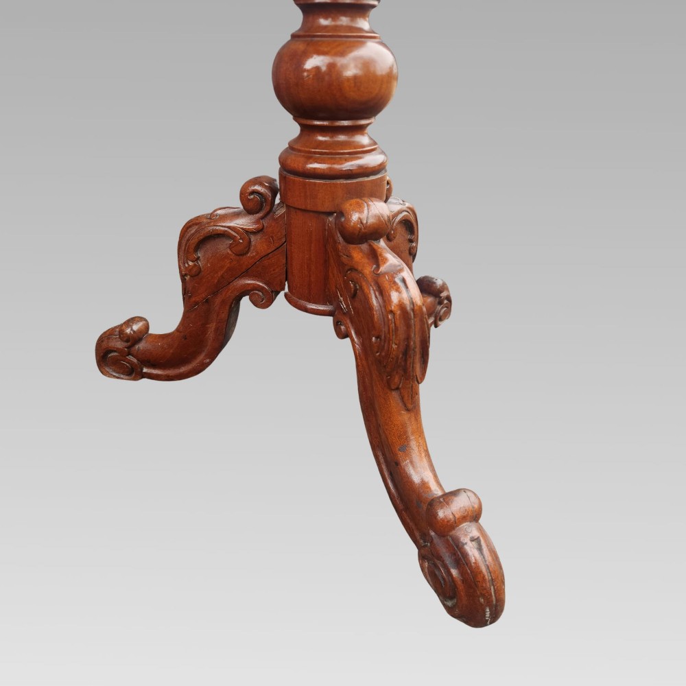 A 19th-century Victorian mahogany side table featuring a rectangular tilt top supported by a turned baluster column and carved tripod legs. View V