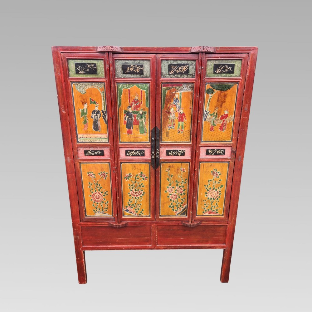 A tall red lacquered Chinese cabinet featuring four vertical doors decorated with hand-painted figurative scenes and floral motifs. View II
