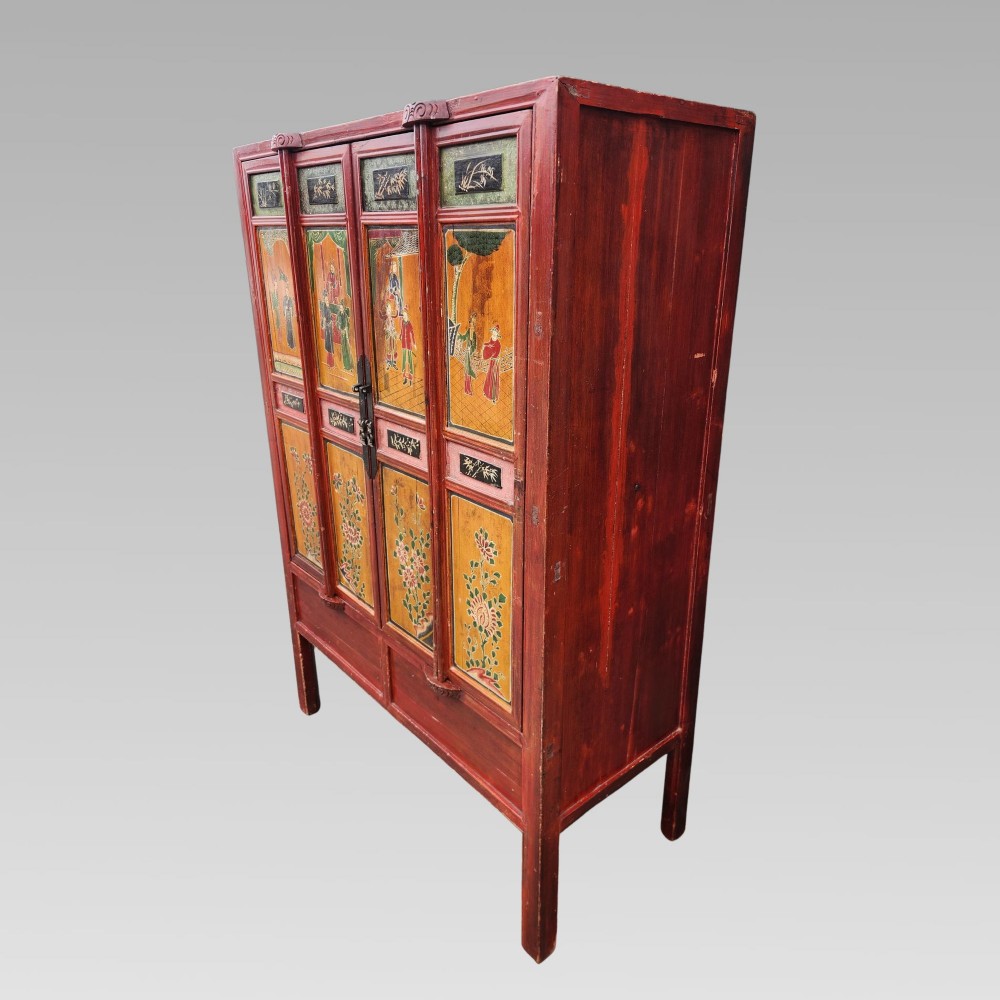 A tall red lacquered Chinese cabinet featuring four vertical doors decorated with hand-painted figurative scenes and floral motifs. View VI
