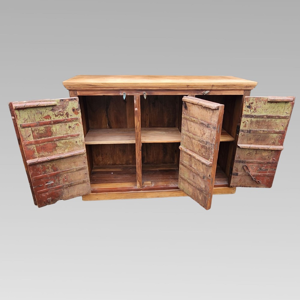 A rustic three-door reclaimed teak sideboard featuring hand-carved floral pilasters, iron ring handles, and metal stud accents. View III