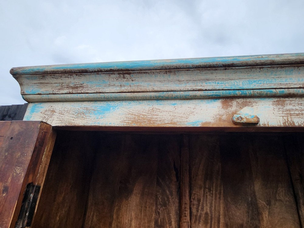A tall reclaimed teak cupboard featuring two double doors with upper vertical metal slats and a distressed blue and raw timber finish. View VII
