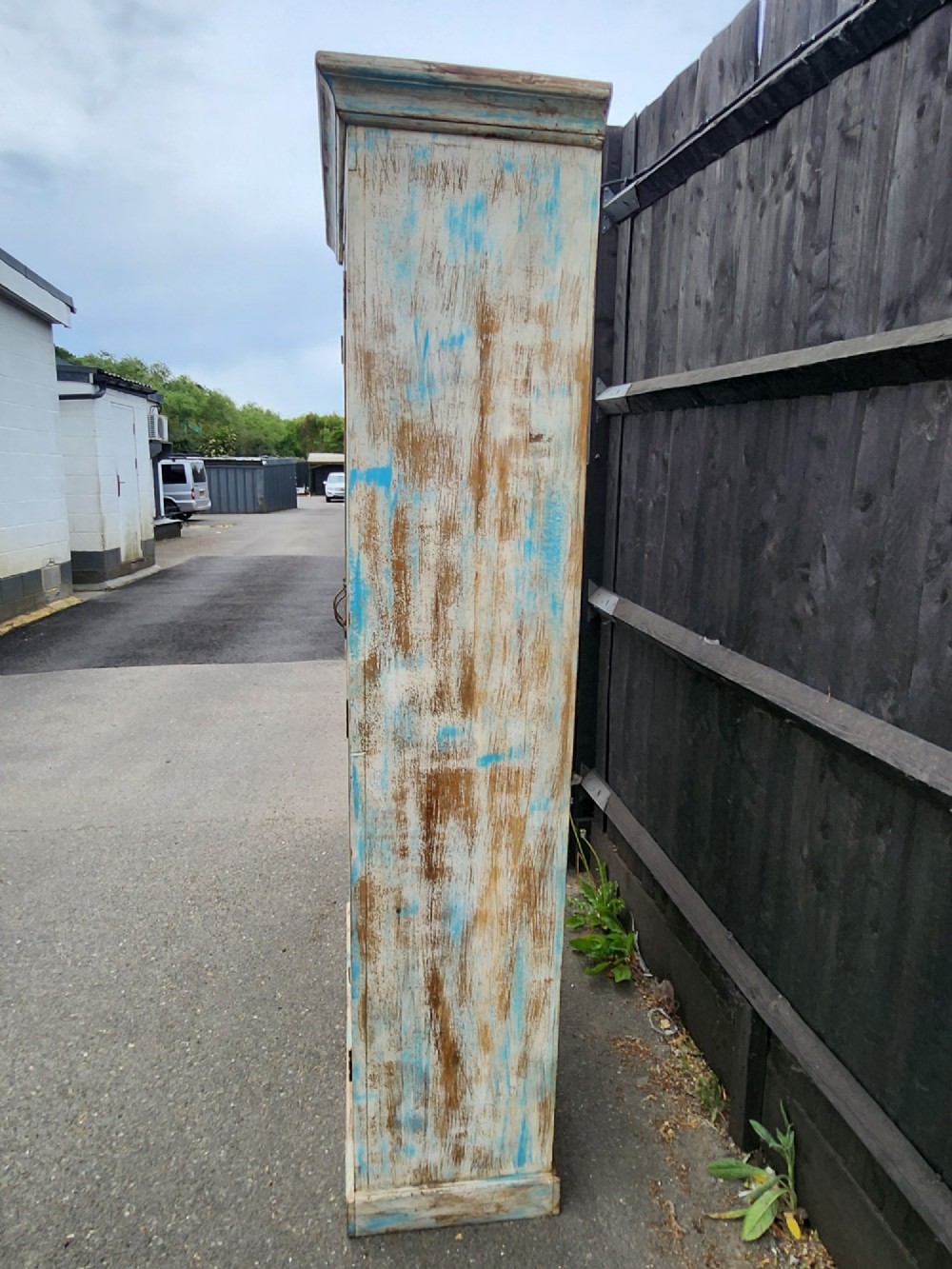 A tall reclaimed teak cupboard featuring two double doors with upper vertical metal slats and a distressed blue and raw timber finish. View XI