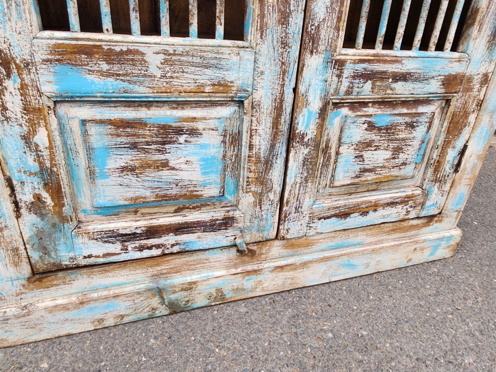 A tall reclaimed teak cupboard featuring two double doors with upper vertical metal slats and a distressed blue and raw timber finish. View XIV