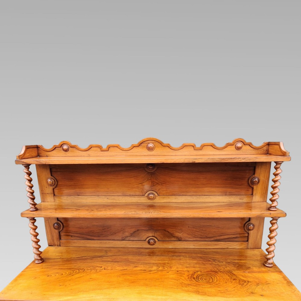 A late Victorian warm brown walnut open buffet sideboard featuring barley twist columns, two upper display shelves, and open base shelving. View IV