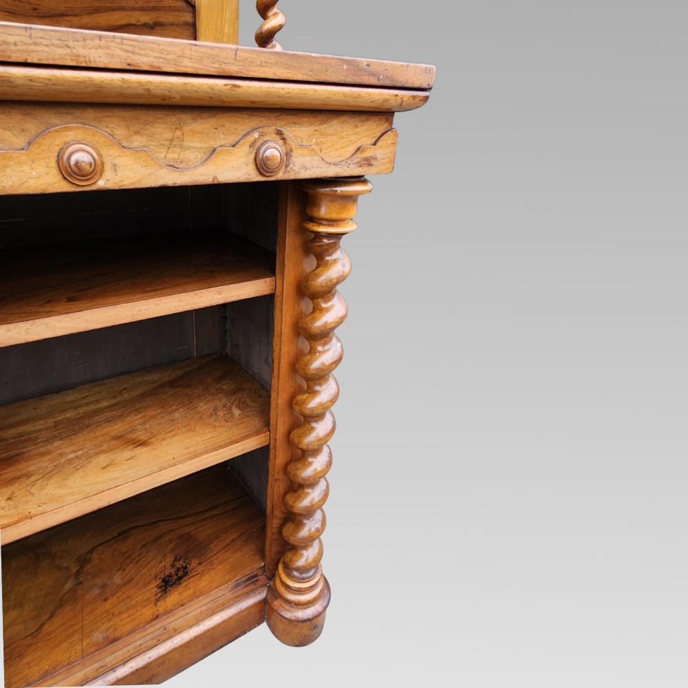 A late Victorian warm brown walnut open buffet sideboard featuring barley twist columns, two upper display shelves, and open base shelving. View V