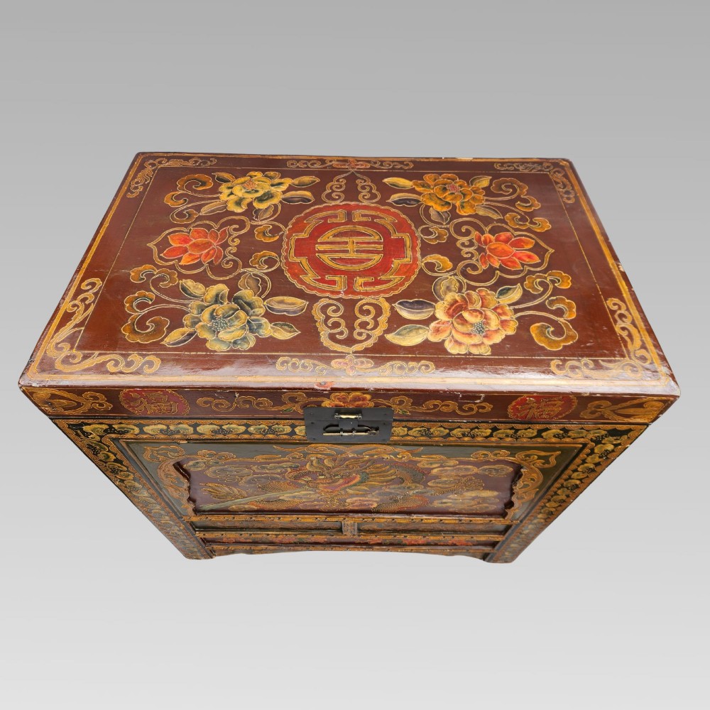 A large antique Chinese wooden storage chest decorated with hand-painted polychrome dragon motifs, floral borders, and brass hardware. View III