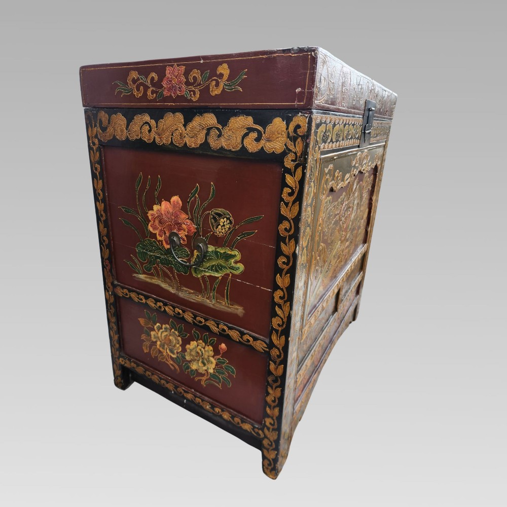 A large antique Chinese wooden storage chest decorated with hand-painted polychrome dragon motifs, floral borders, and brass hardware. View IV