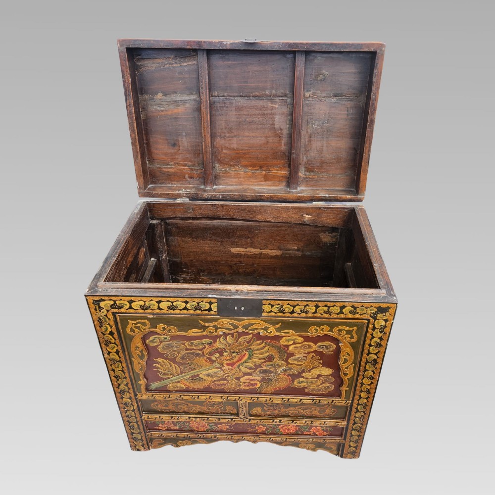 A large antique Chinese wooden storage chest decorated with hand-painted polychrome dragon motifs, floral borders, and brass hardware. View VI