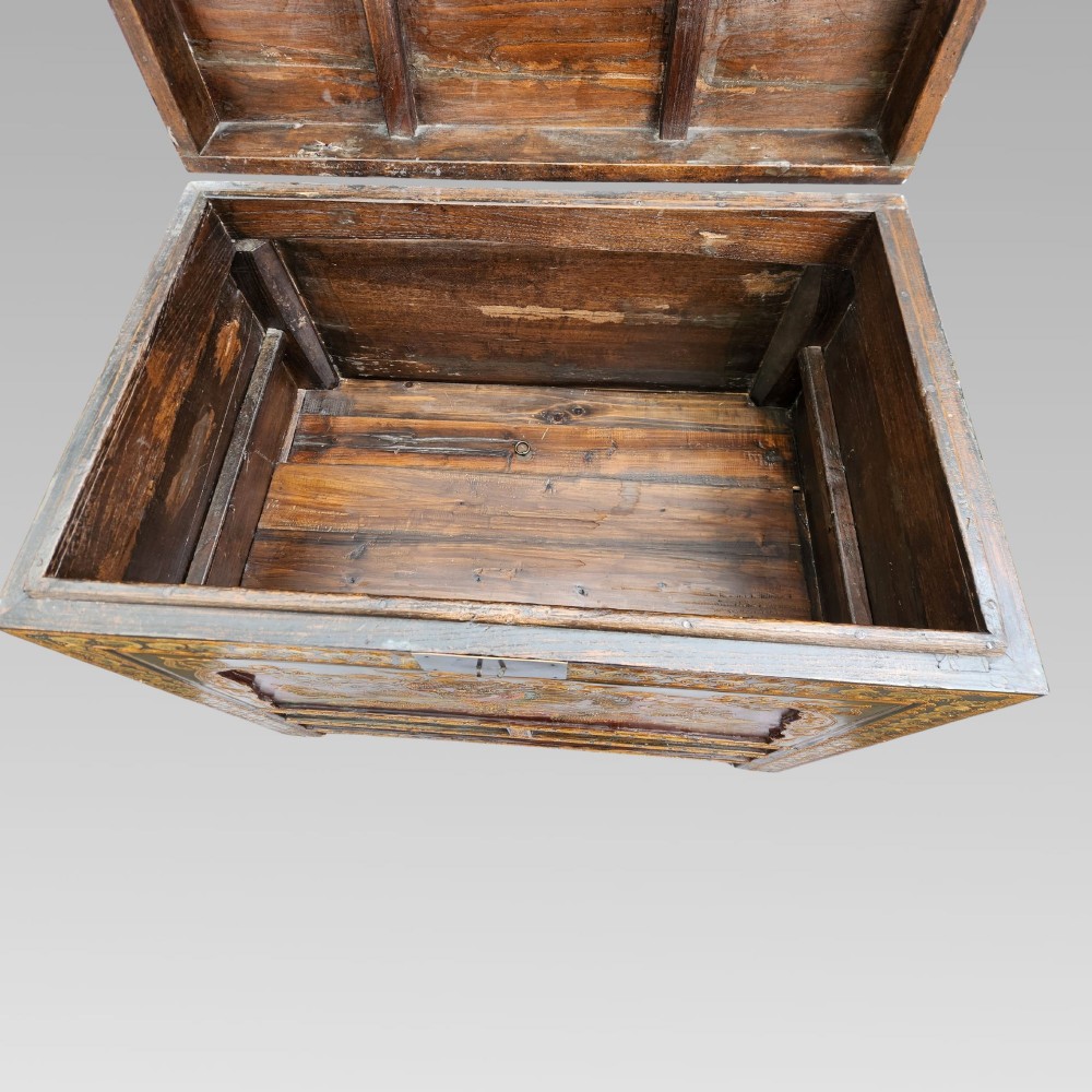 A large antique Chinese wooden storage chest decorated with hand-painted polychrome dragon motifs, floral borders, and brass hardware. View VII