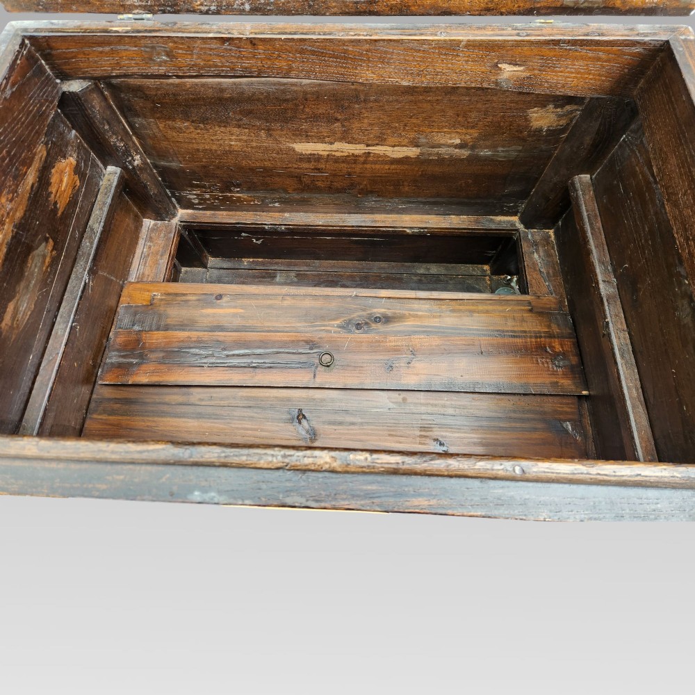 A large antique Chinese wooden storage chest decorated with hand-painted polychrome dragon motifs, floral borders, and brass hardware. View VIII