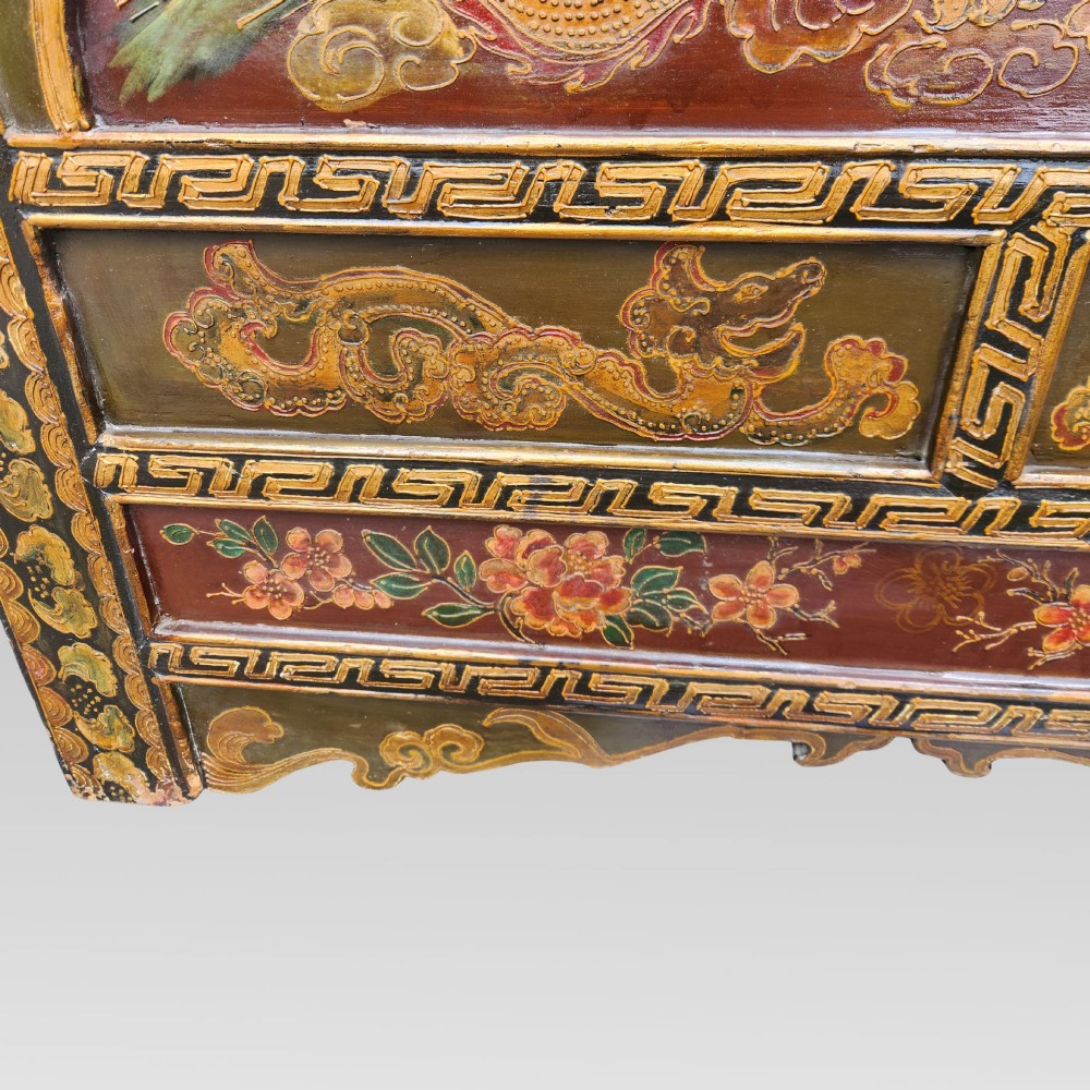 A large antique Chinese wooden storage chest decorated with hand-painted polychrome dragon motifs, floral borders, and brass hardware. View XIII