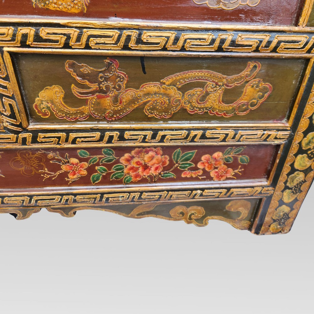 A large antique Chinese wooden storage chest decorated with hand-painted polychrome dragon motifs, floral borders, and brass hardware. View XIV
