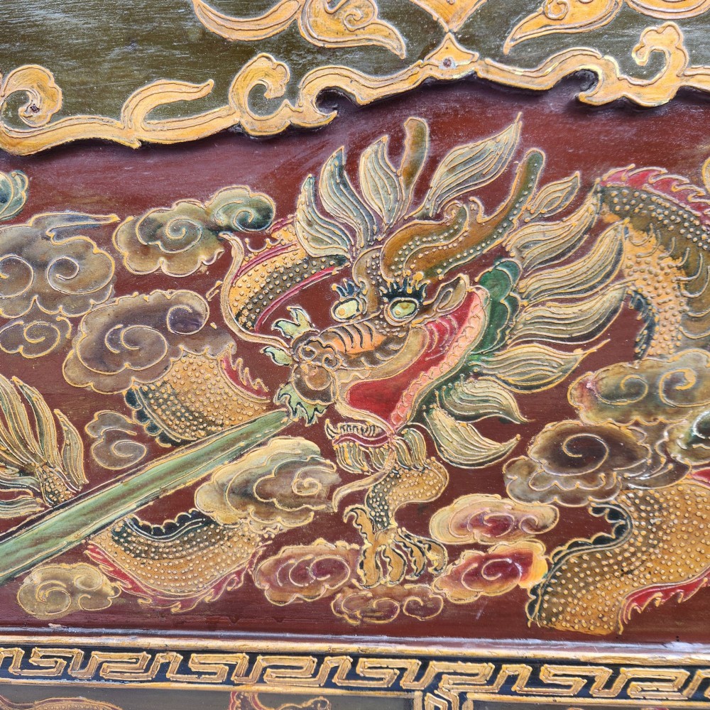 A large antique Chinese wooden storage chest decorated with hand-painted polychrome dragon motifs, floral borders, and brass hardware. View XV