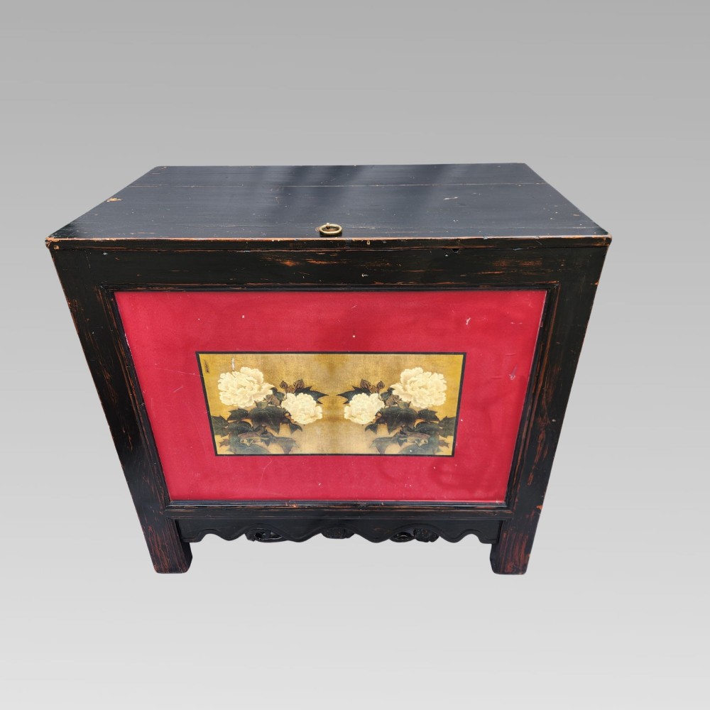 A dark lacquered wooden storage chest featuring a framed red panel with a hand-painted floral image of white peonies on a gold background. View II