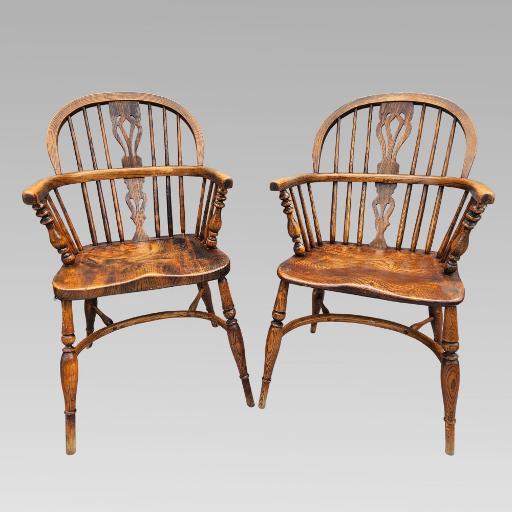A pair of antique wooden Windsor armchairs featuring shaped elm seats, spindle backs with pierced central splats, and curved crinoline stretchers. View II