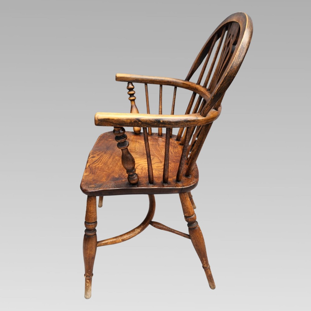 A pair of antique wooden Windsor armchairs featuring shaped elm seats, spindle backs with pierced central splats, and curved crinoline stretchers. View IX