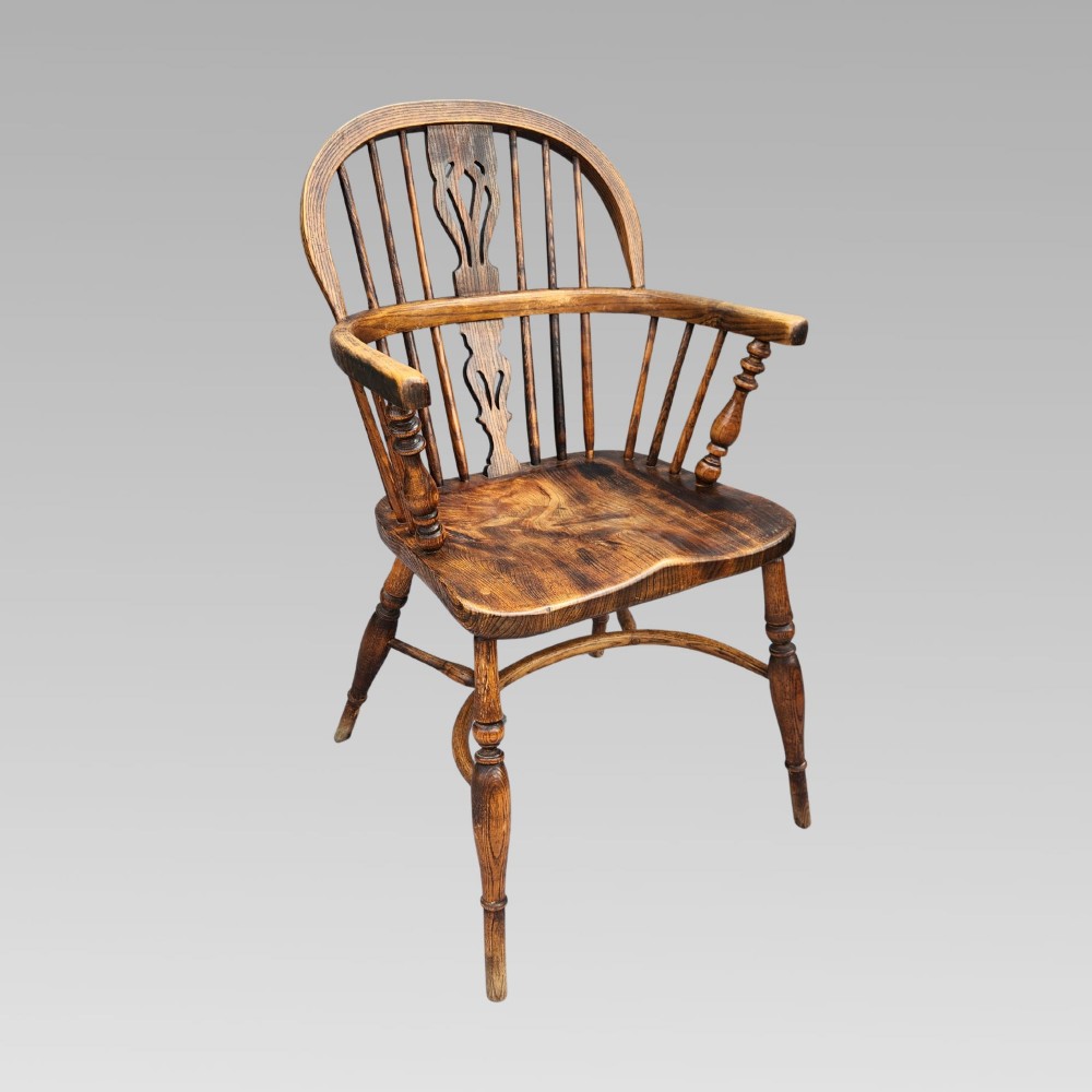 A pair of antique wooden Windsor armchairs featuring shaped elm seats, spindle backs with pierced central splats, and curved crinoline stretchers. View XIII