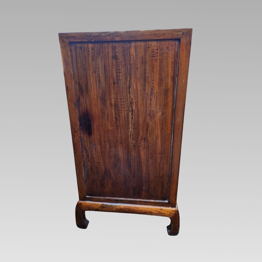 A tall warm brown elm apothecary chest featuring sixteen small labelled drawers above two wider base drawers with metal ring pulls. View VI