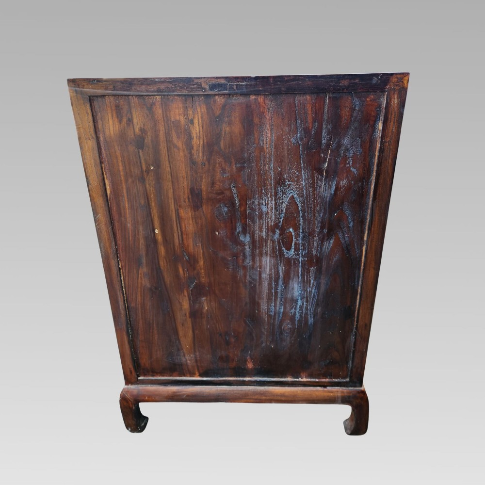A tall warm brown elm apothecary chest featuring sixteen small labelled drawers above two wider base drawers with metal ring pulls. View VII
