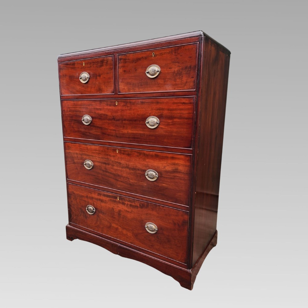 A Victorian flame mahogany chest of drawers featuring two short over three long drawers with oval brass handles. View III