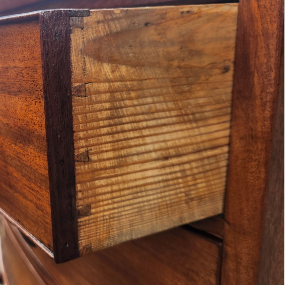 A Victorian mahogany bow-front chest of drawers featuring two short drawers over three long drawers with dark turned handles and turned feet. View VIII