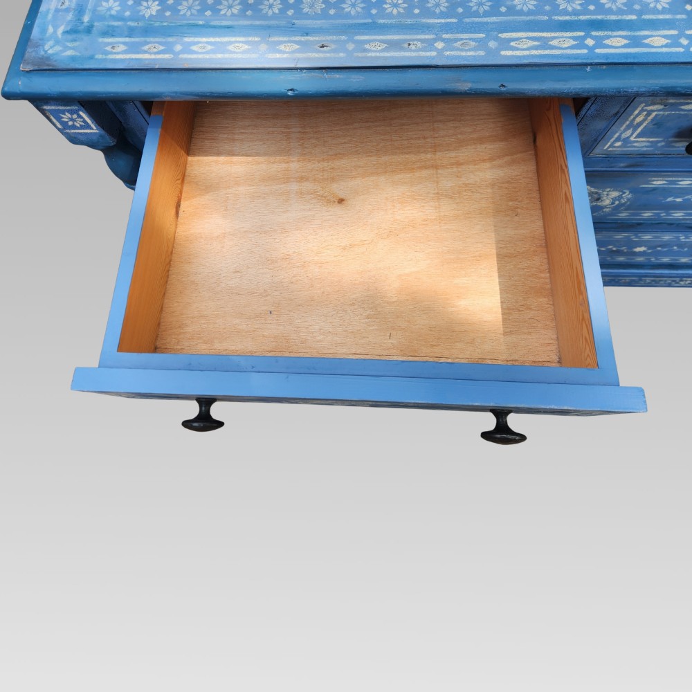 A hand-painted blue pine chest of drawers featuring white elephant motifs and dark metal knob handles. View V