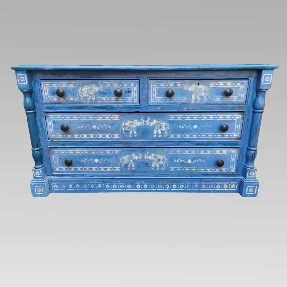 A hand-painted blue pine chest of drawers featuring white elephant motifs and dark metal knob handles. View VI
