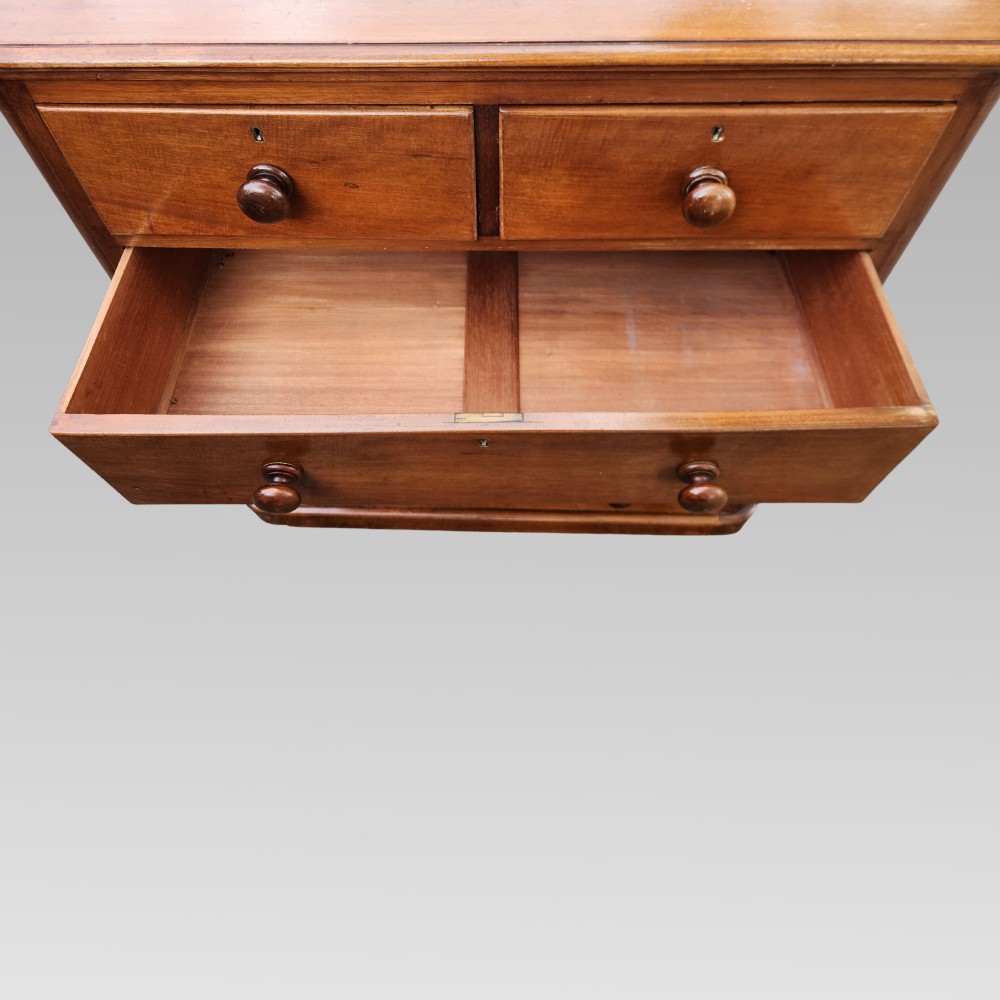 A Victorian mahogany chest of drawers featuring two short drawers above three full-width graduated drawers with turned wooden handles and a plinth base. View IV