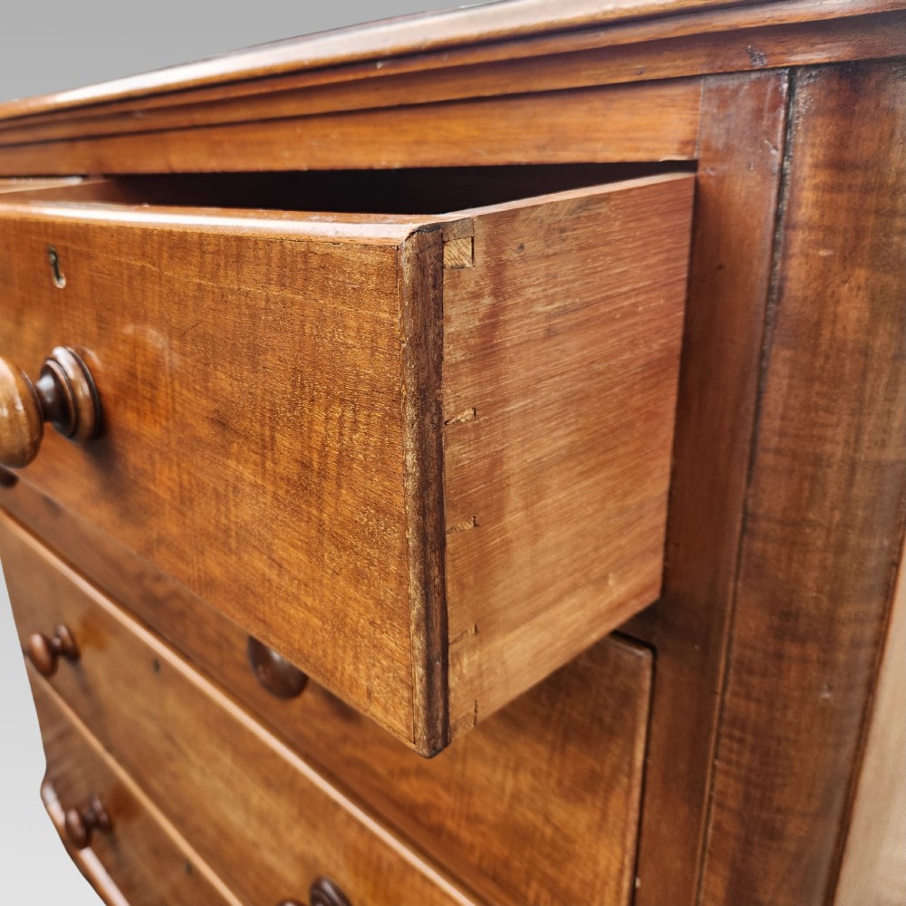 A Victorian mahogany chest of drawers featuring two short drawers above three full-width graduated drawers with turned wooden handles and a plinth base. View VIII