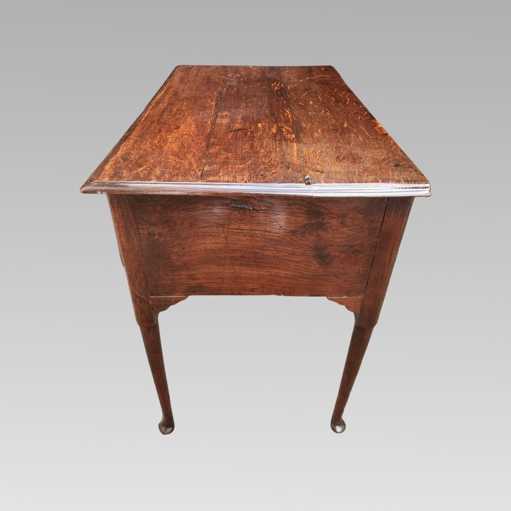 An antique Georgian oak lowboy side table featuring three front drawers with brass handles, a shaped apron, and four slender cabriole legs. View VI
