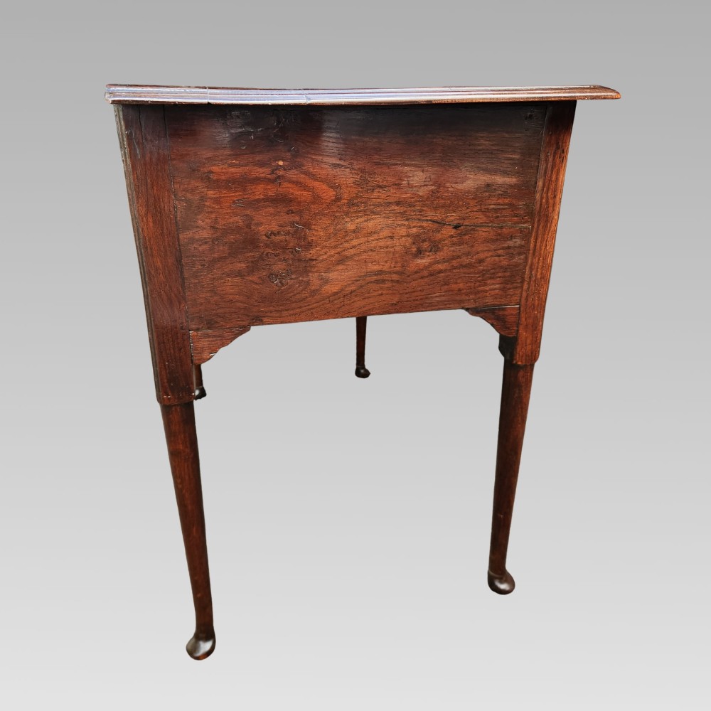 An antique Georgian oak lowboy side table featuring three front drawers with brass handles, a shaped apron, and four slender cabriole legs. View VII
