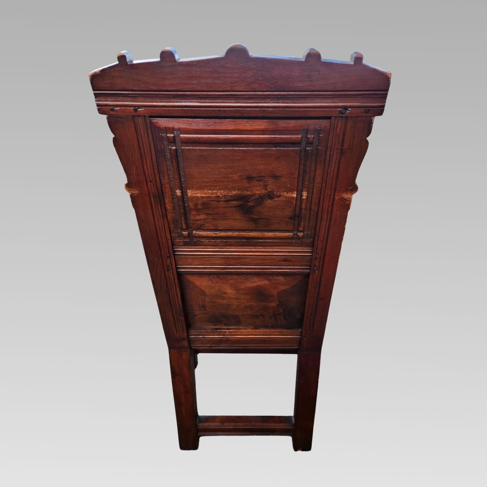 A dark oak wainscot armchair featuring a carved back panel with an equestrian motif, dated cresting rail, and turned legs. View VI