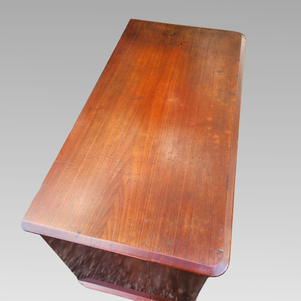 A Victorian mahogany chest of drawers featuring two short drawers over two long drawers with turned wooden handles, brass escutcheons, and a solid plinth base. View III