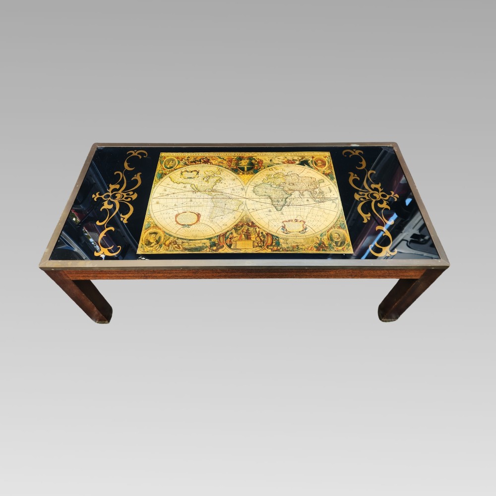 A dark mahogany campaign style nest of three coffee tables featuring glass tops with inset world map illustrations and brass corner mounts. View III