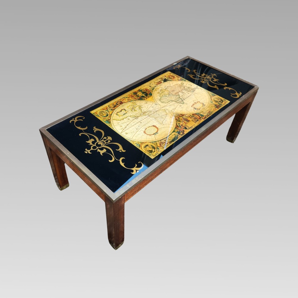 A dark mahogany campaign style nest of three coffee tables featuring glass tops with inset world map illustrations and brass corner mounts. View V