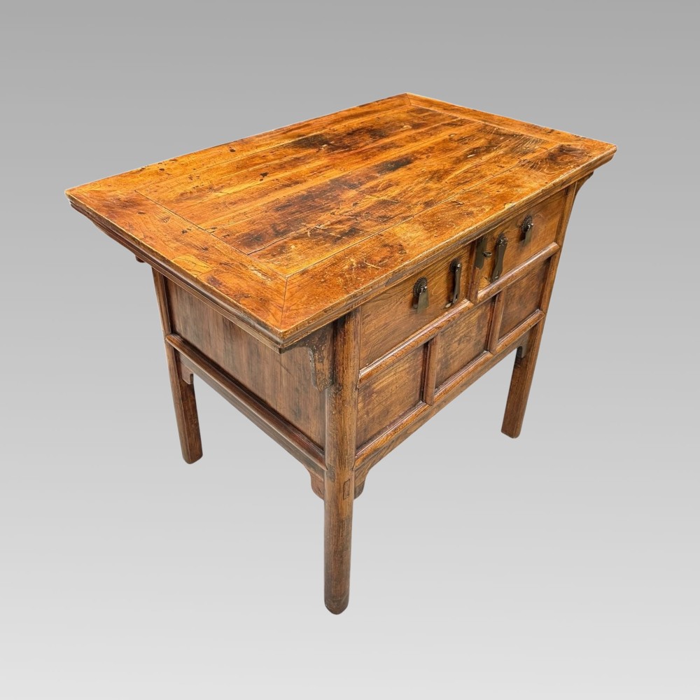 A warm brown Chinese elm console table featuring two upper drawers with metal drop handles and lower recessed timber panels. View II