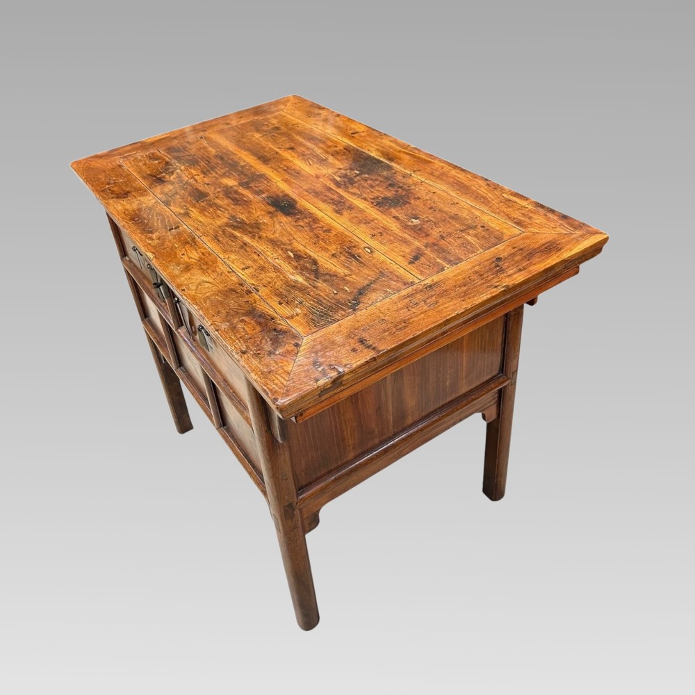 A warm brown Chinese elm console table featuring two upper drawers with metal drop handles and lower recessed timber panels. View III