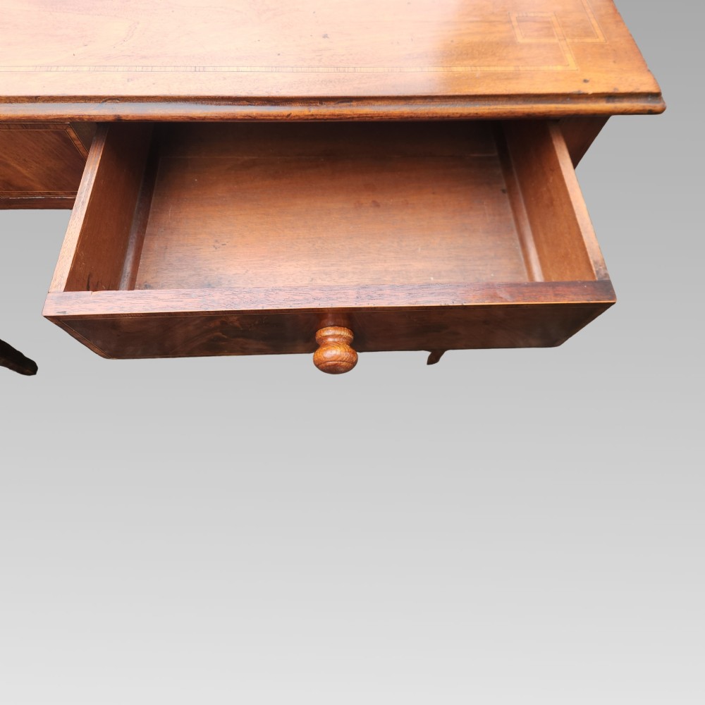 A Victorian mahogany side table featuring decorative satinwood geometric inlay on the rectangular top, two drawers with wooden knobs, and four tapered legs. View V