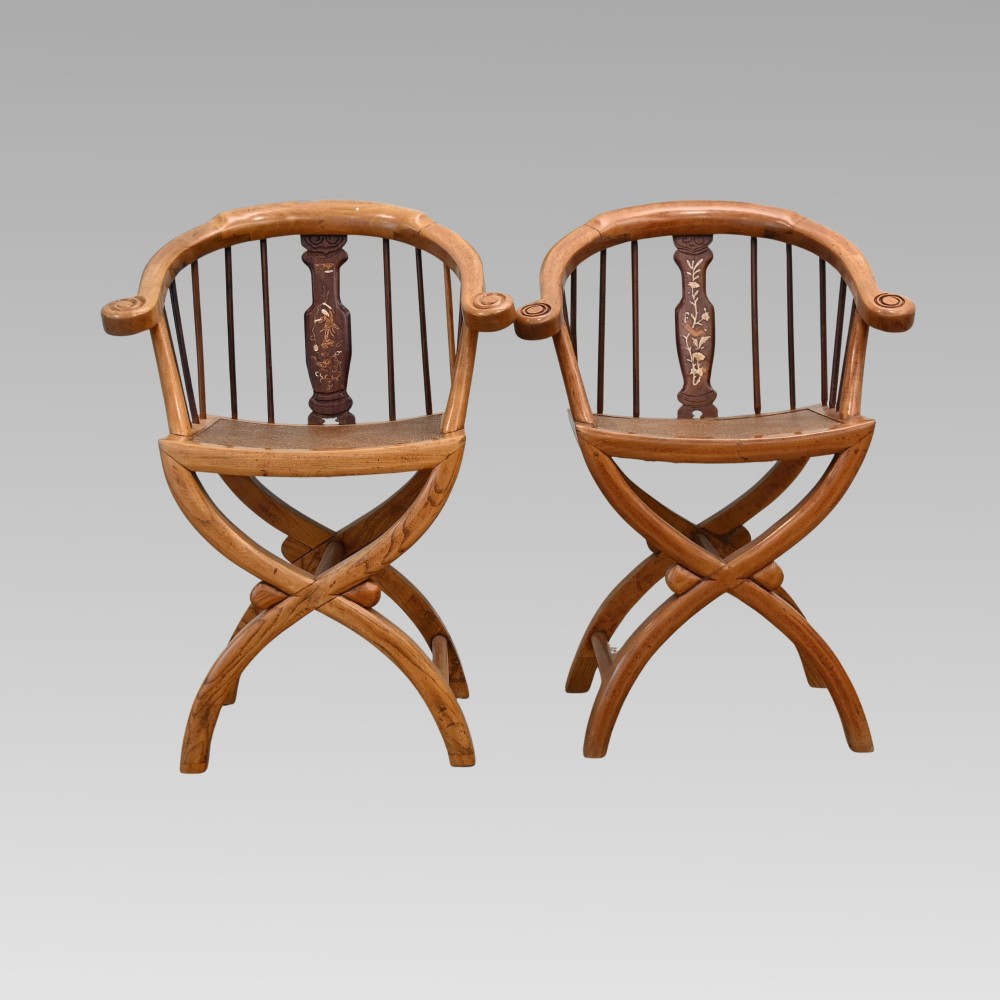 A pair of Chinese fruitwood horseshoe chairs featuring curved crest rails, vertical spindles, woven cane seats, cross-framed legs, and central carved splats with bone inlay. View II