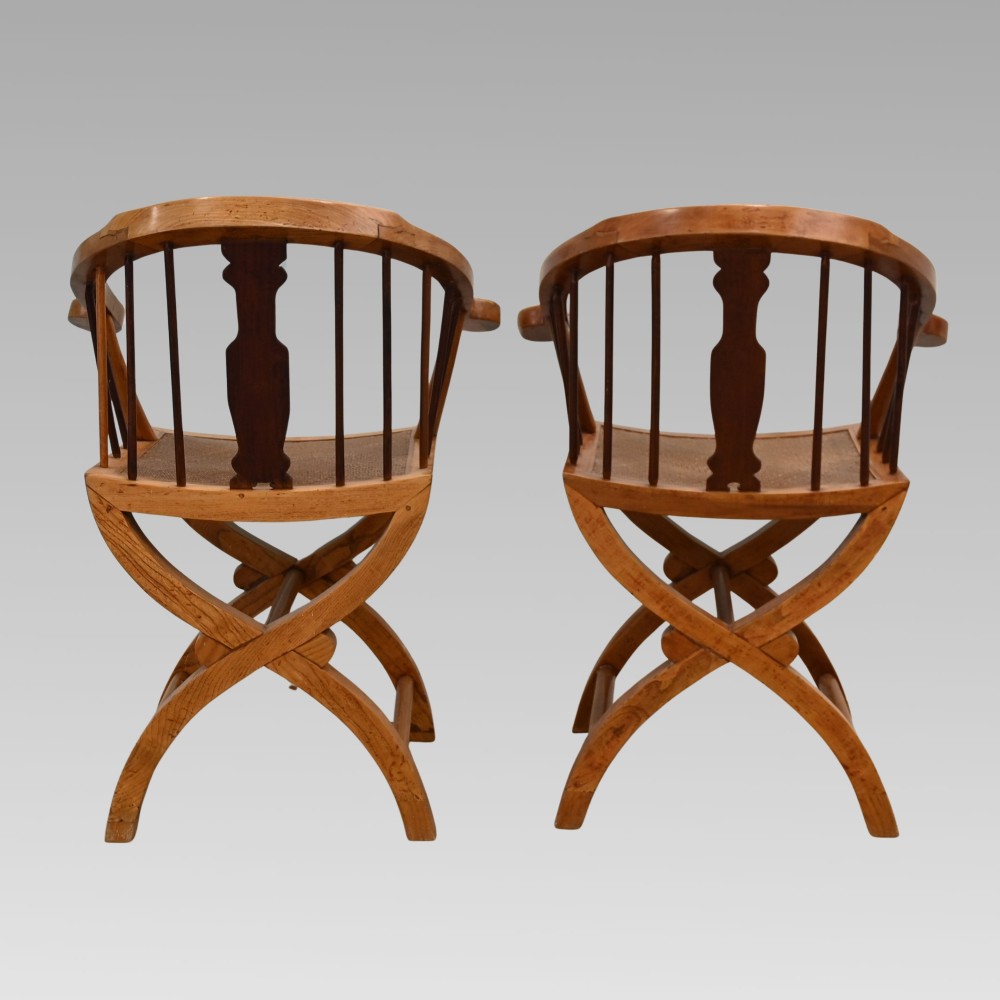 A pair of Chinese fruitwood horseshoe chairs featuring curved crest rails, vertical spindles, woven cane seats, cross-framed legs, and central carved splats with bone inlay. View IV