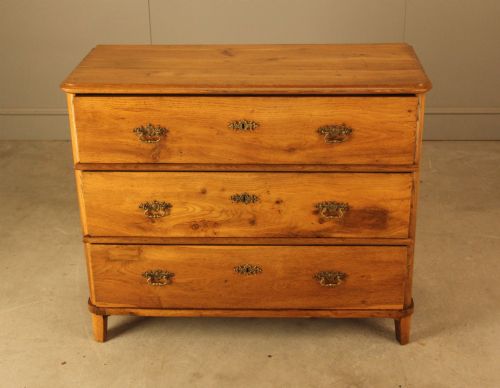 fig 2. A 19th-century Swedish oak secretaire chest featuring an open hinged fall-front writing flap revealing fitted interior drawers, positioned above two large lower drawers.