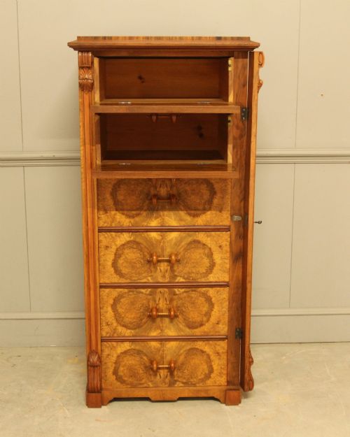 fig 4. A tall 19th-century Swedish Wellington chest featuring six book-matched burr walnut drawers with turned handles, flanked by carved pilasters.