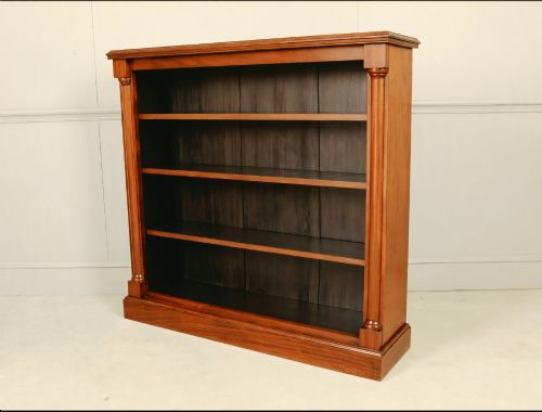 fig 3. A Victorian open mahogany bookcase featuring four shelves flanked by turned pilasters on a solid plinth base.
