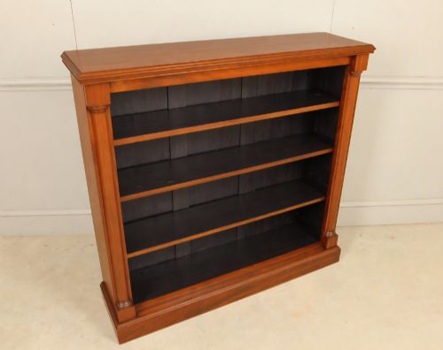 fig 4. A Victorian open mahogany bookcase featuring four shelves flanked by turned pilasters on a solid plinth base.