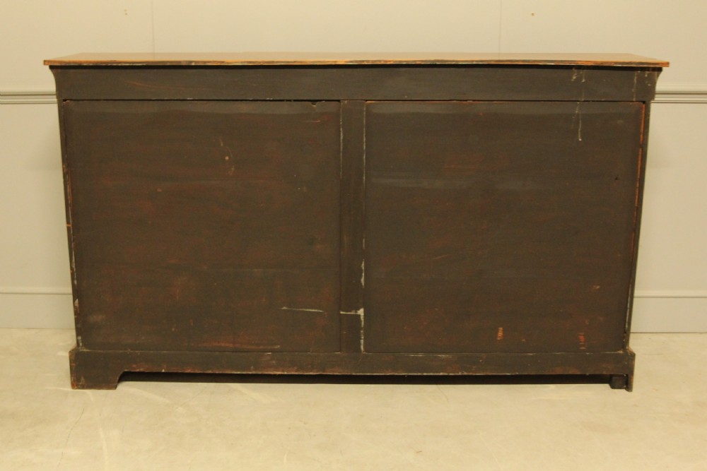 A Victorian low breakfront credenza crafted from burr walnut with marquetry inlay, gilt-brass mounts, a central panelled door, and two outer glazed doors. View XII